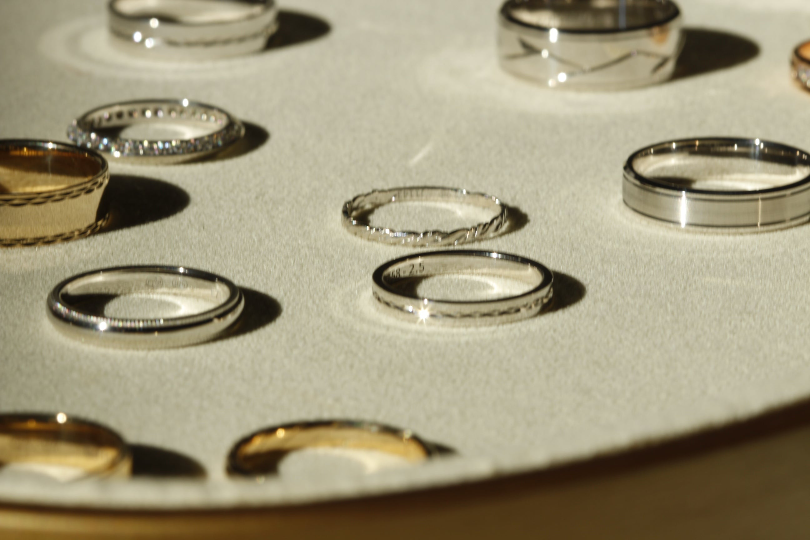 a tray display yellow gold and white gold wedding rings from Orsini Jewellers