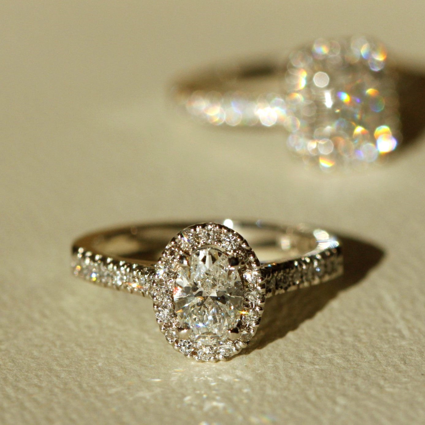 halo engagement oval diamond ring with small diamonds on the side