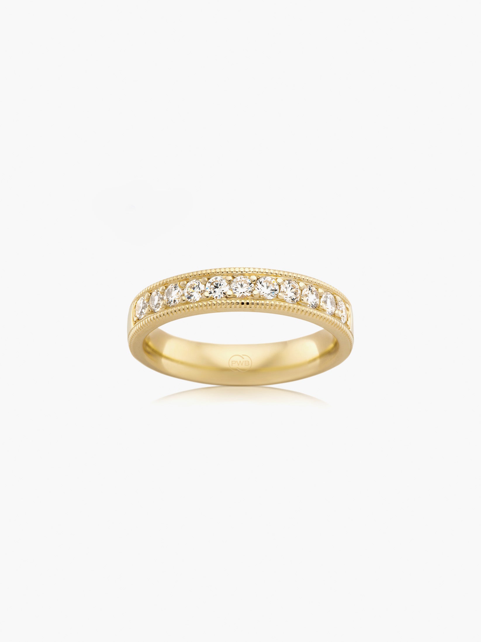 This milgrain diamond wedding ring in yellow gold features a luminous row of diamonds framed by intricate milgrain detailing. Each Orsini wedding ring is crafted to order, allowing you to personalise the design in your preferred metal, width, thickness, and finger size.