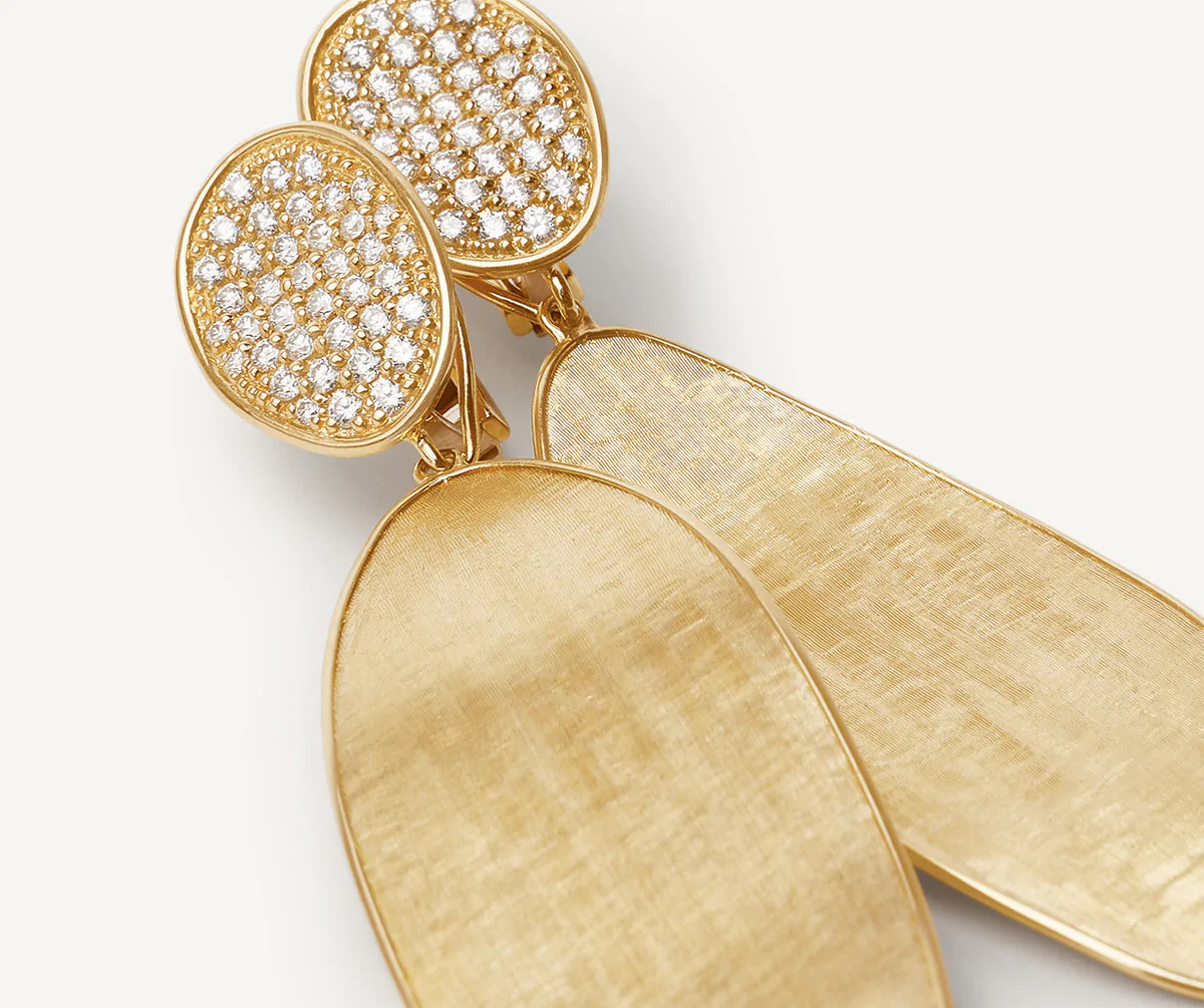 close up of marco bicego lunaria earrings with diamonds in 18k yellow gold