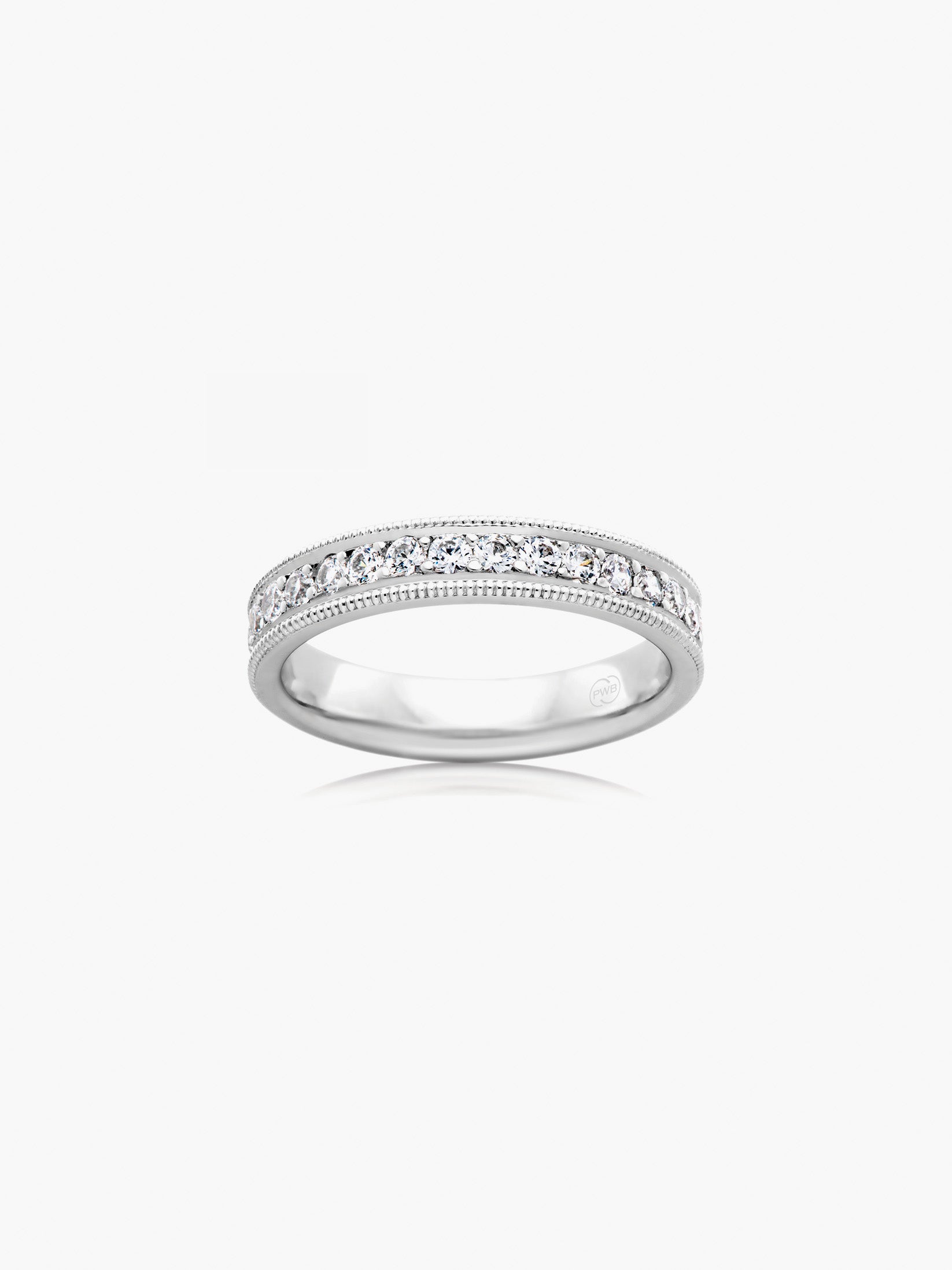 This slender milgrain diamond wedding ring features a refined band profile with delicate milgrain edging framing a line of brilliant diamonds. Each Orsini wedding ring is crafted to order, allowing you to personalise the design in your preferred metal, width, thickness, and finger size.