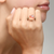 Worn on model maxi Nudo Rose quartz ring in 18k rose gold with brown diamonds