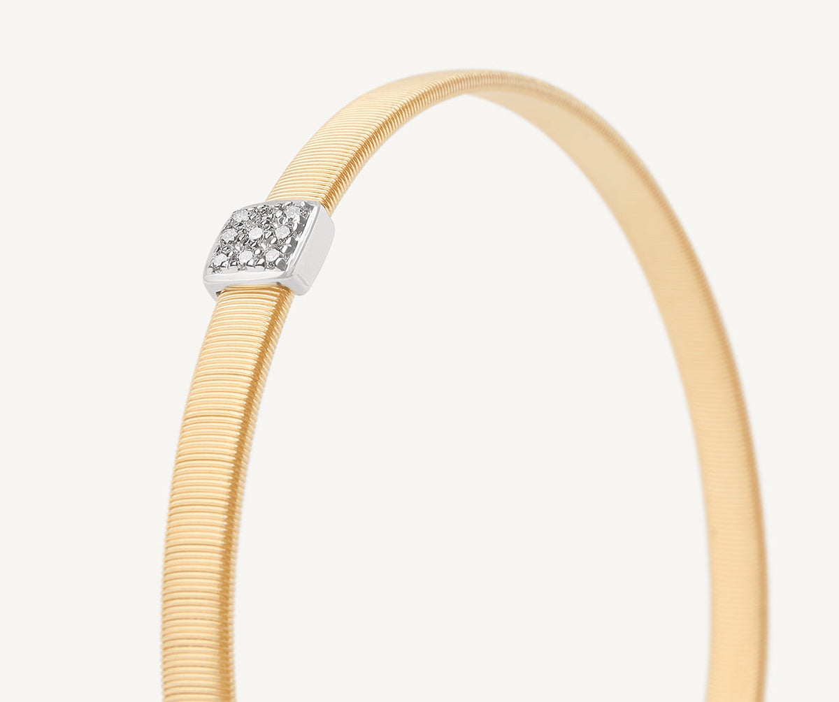 Diamonds set in white gold with yellow gold bracelet by Marco Bicego