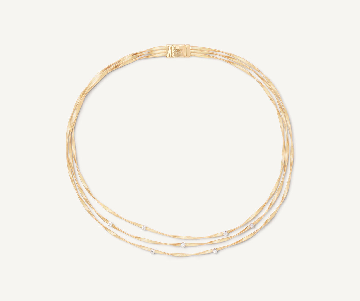 Three strand yellow gold with diamonds Marrakech necklace worn with Marrakech bracelet by Marco Bicego