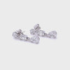 White Gold and diamonds illusion drop earrings lying sideways in light box 