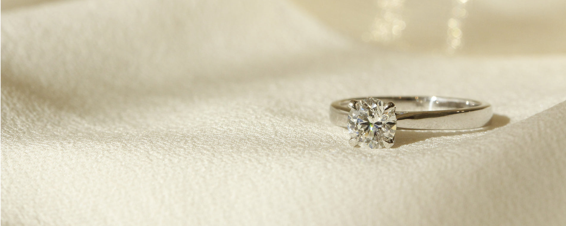 Solitaire diamond 4 claw engagement ring set in white gold Tulipano setting by Orsini Fine Jewellery horizontal cropped image 