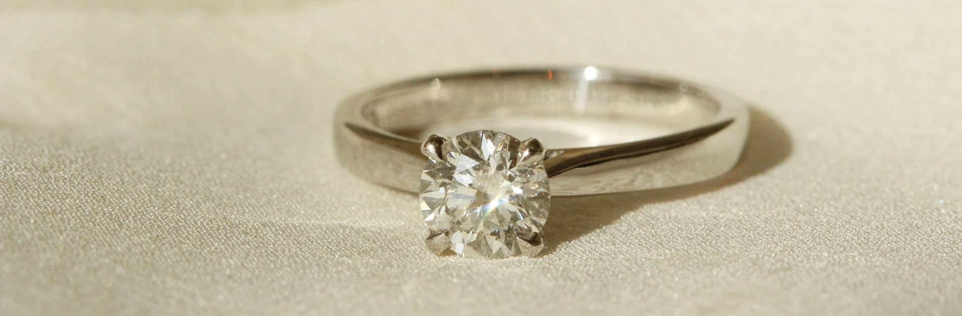 Classic engagement ring design close up of ring solitaire diamond gold band Tulipano setting banner image