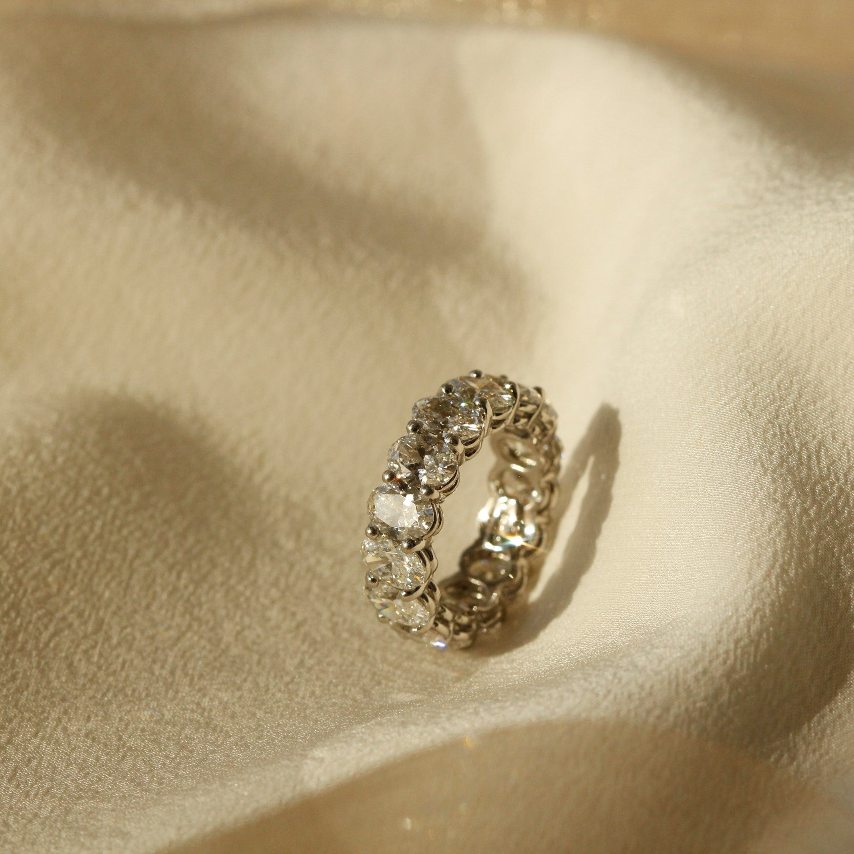Diamond Eternity Ring with oval brilliant cut diamonds in Platinum on Fabric