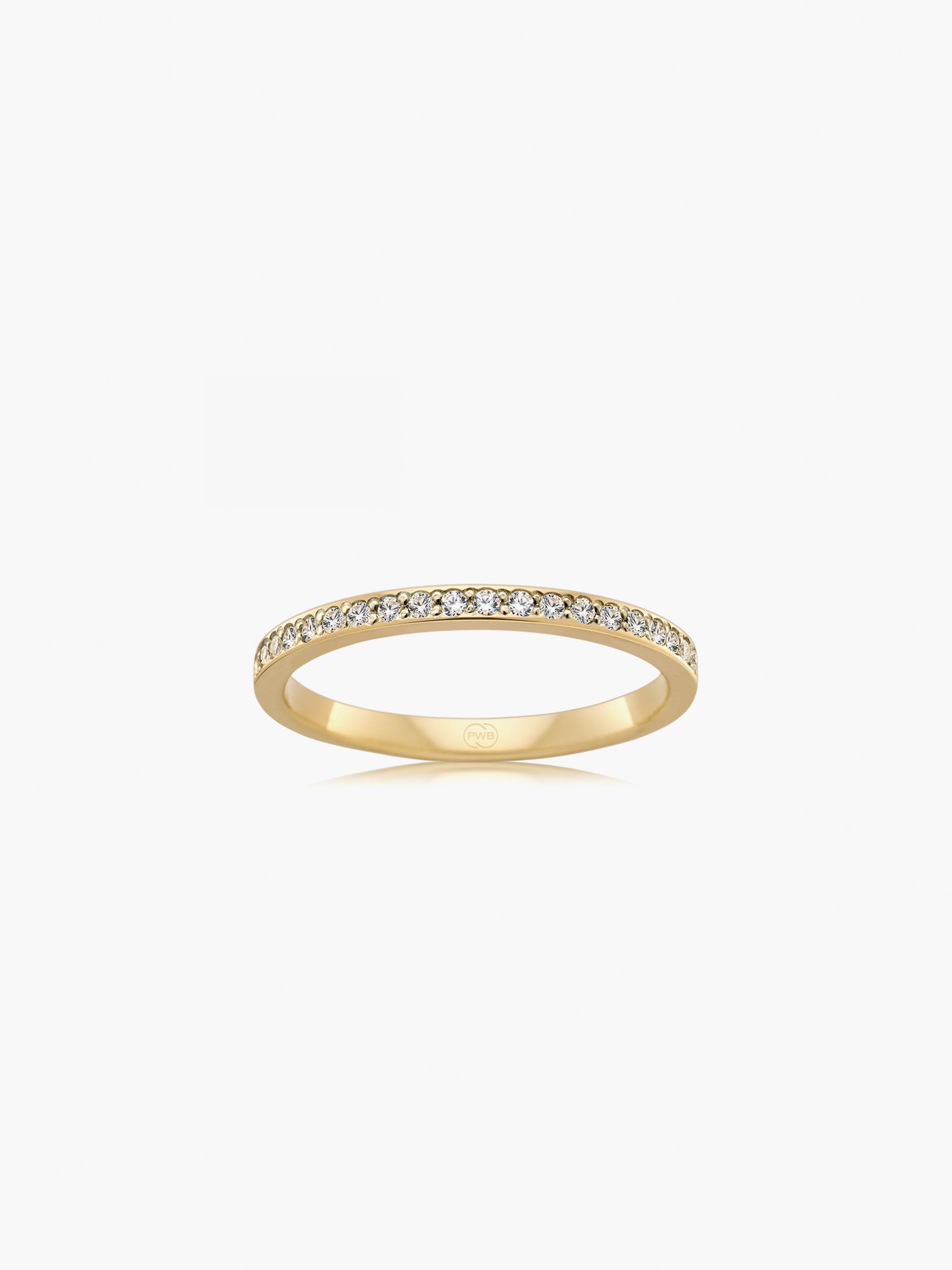 This slim bead set diamond wedding ring in yellow gold showcases a delicate row of brilliant cut diamonds framed within a refined band. Each Orsini wedding ring is crafted to order, allowing you to personalise the design in your preferred metal, width, thickness, and finger size.