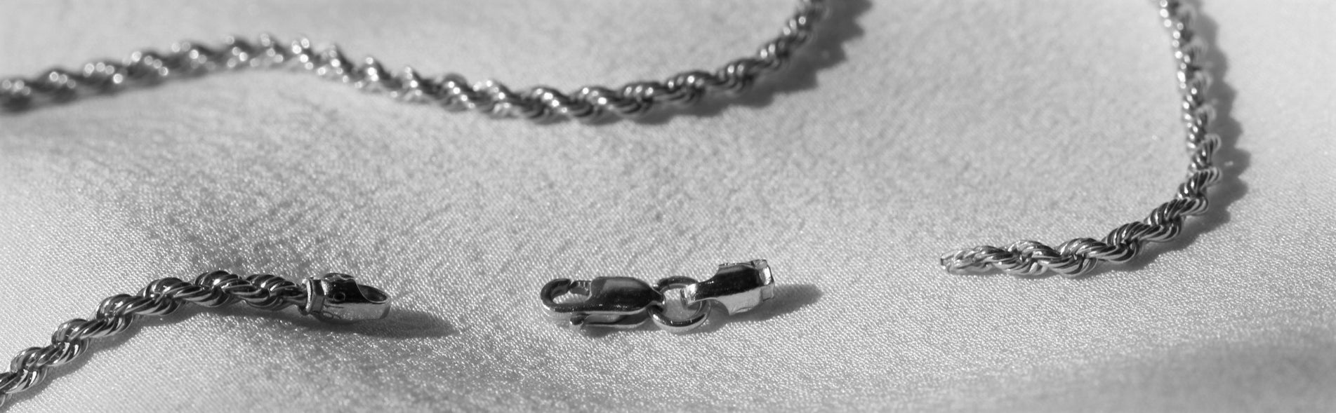 Black and white image of gold chain broken for jewellery repairs and alterations at Orsini Fine Jewellery