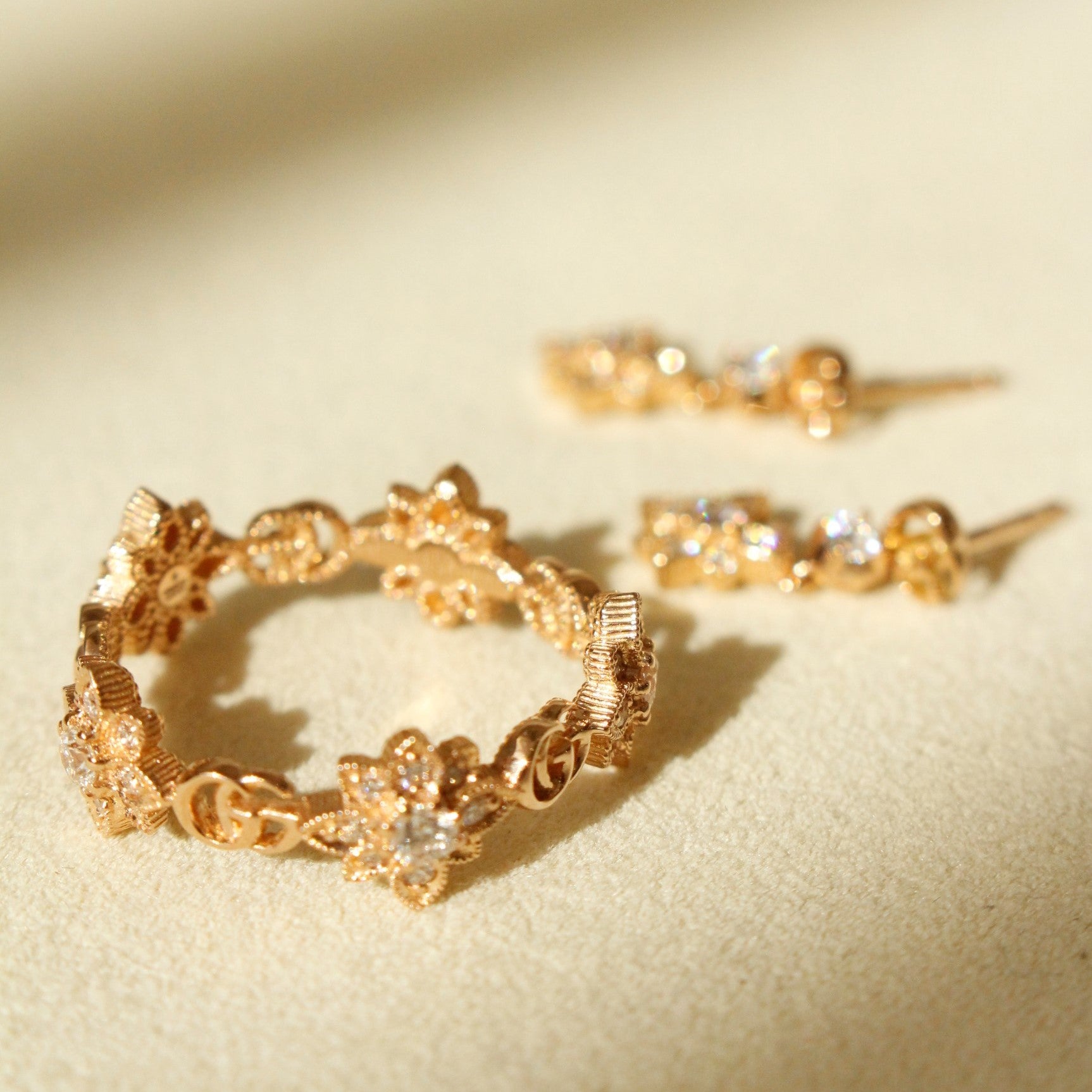 Rose gold and diamonds Gucci Flora ring with Flora earrings in background