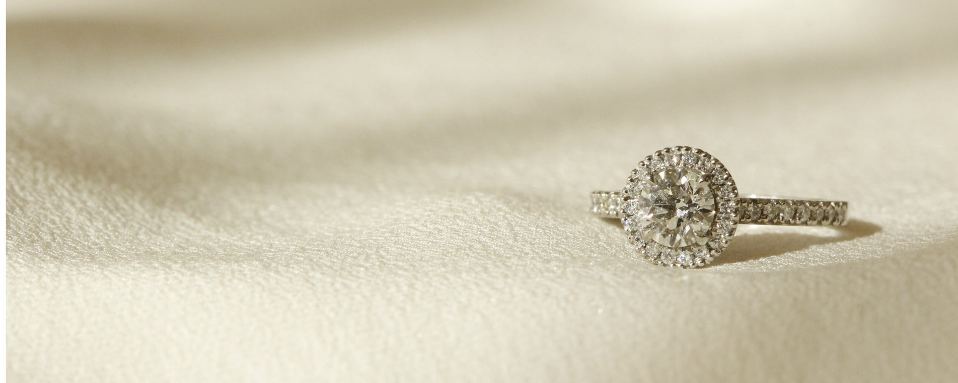 Round diamond with diamond halo and diamonds on band engagement ring design Le Fenice Round setting by Orsini Fine Jewellery horizontal cropped image 