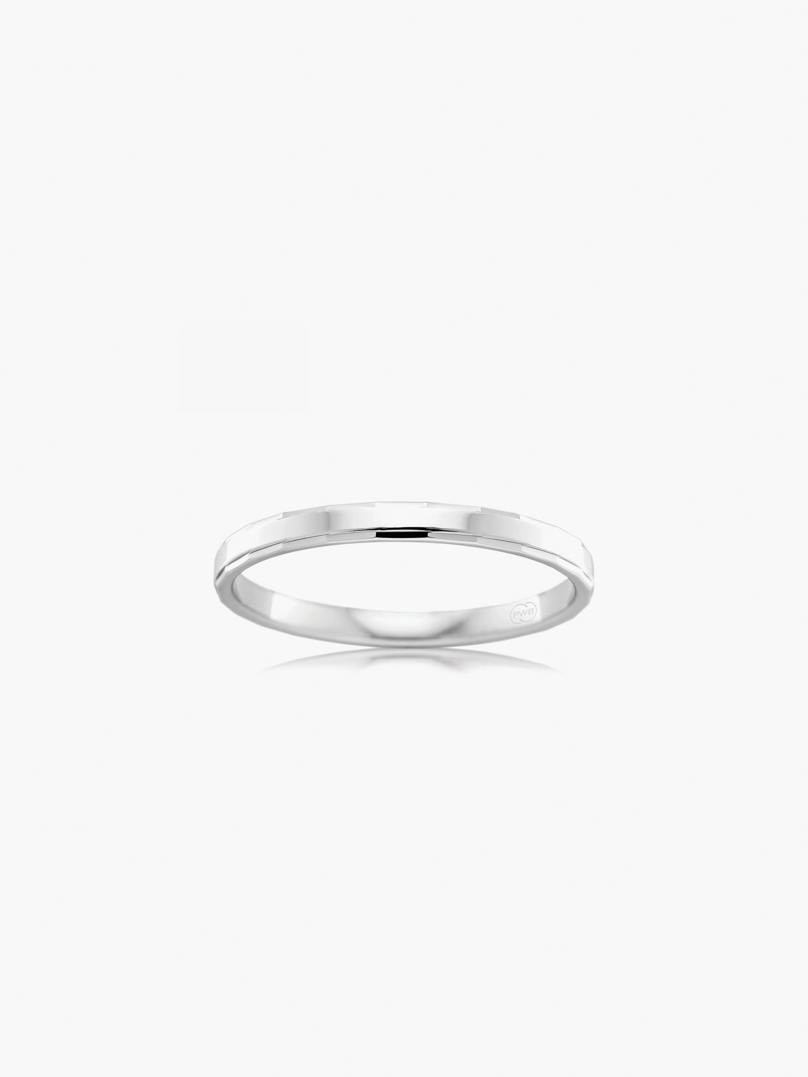 A refined white gold wedding ring featuring delicate edge pattern detailing for subtle texture.