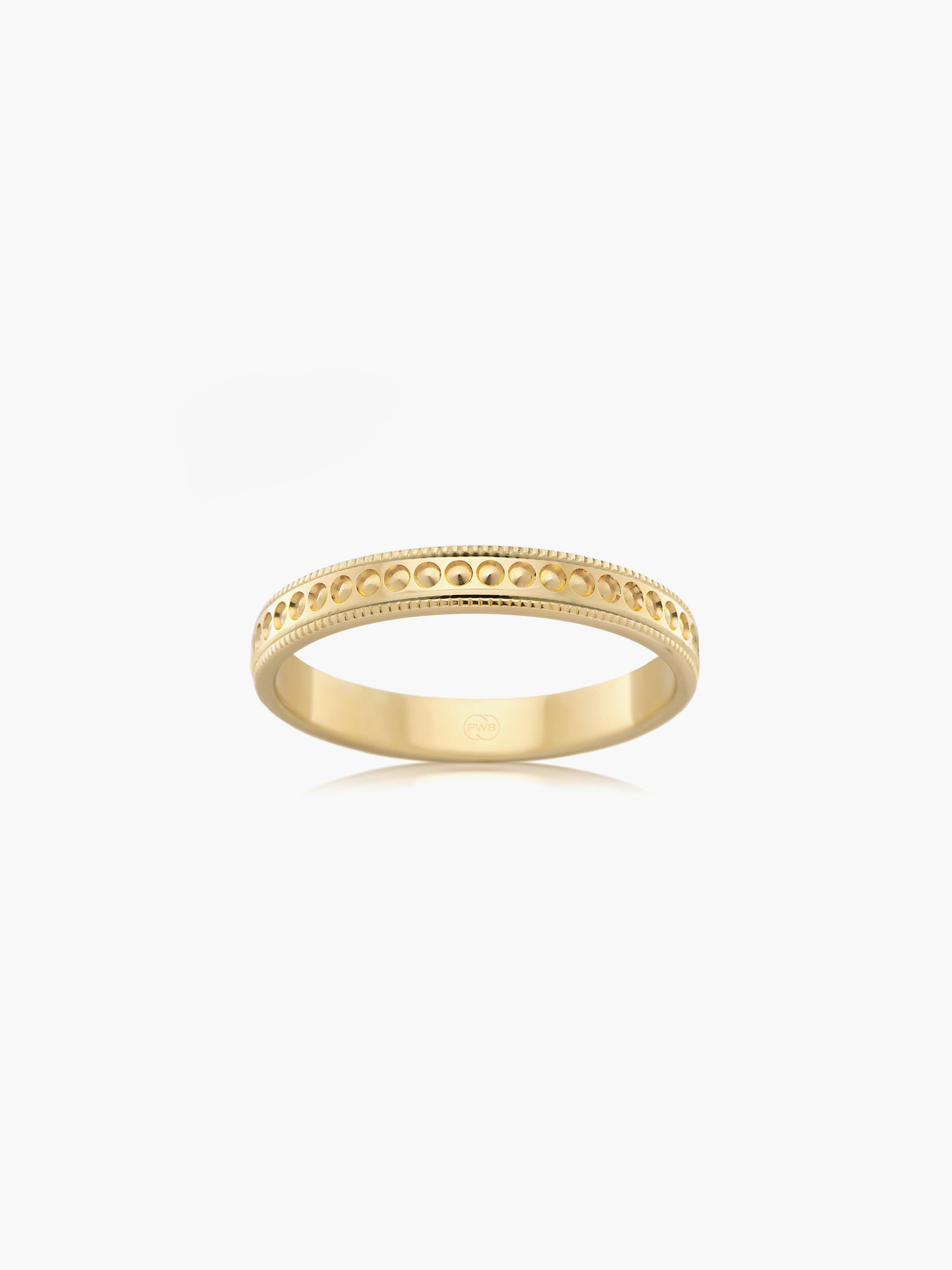 A refined wedding ring in yellow gold, detailed with delicate milgrain edges and a softly studded centre.