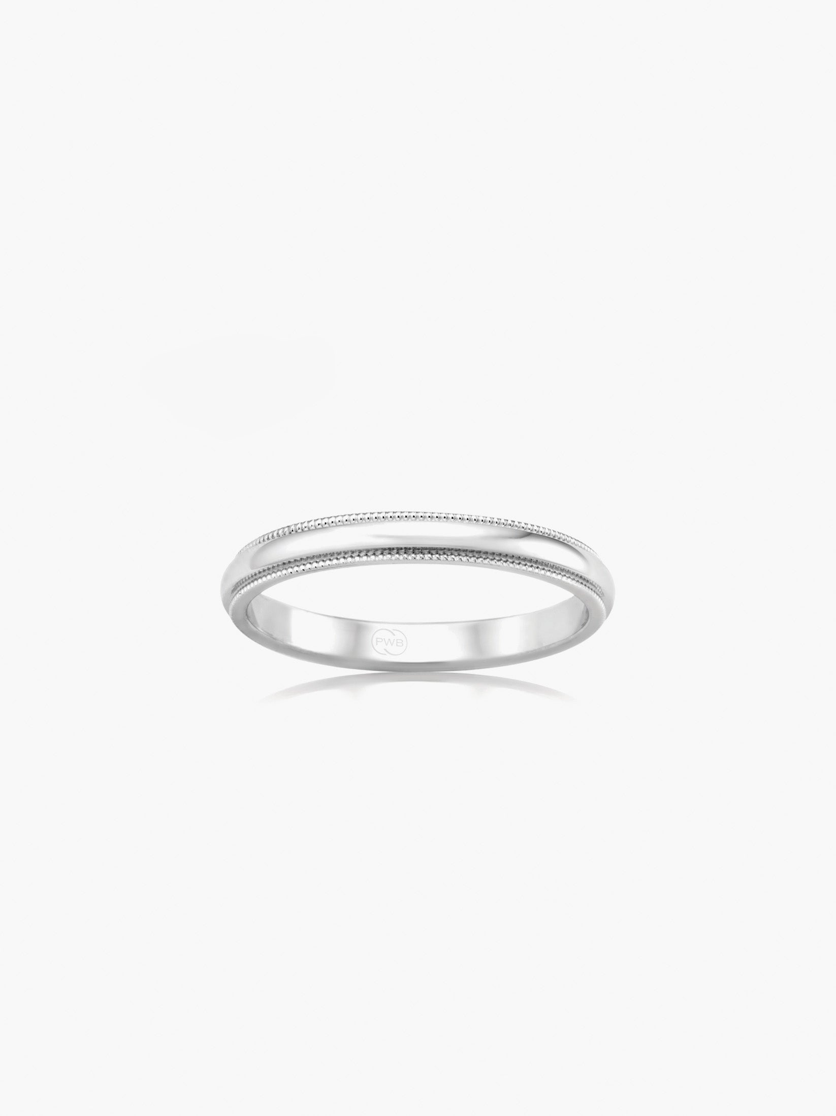 A refined white gold wedding ring with a gently rounded profile and fine milgrain edge detail.