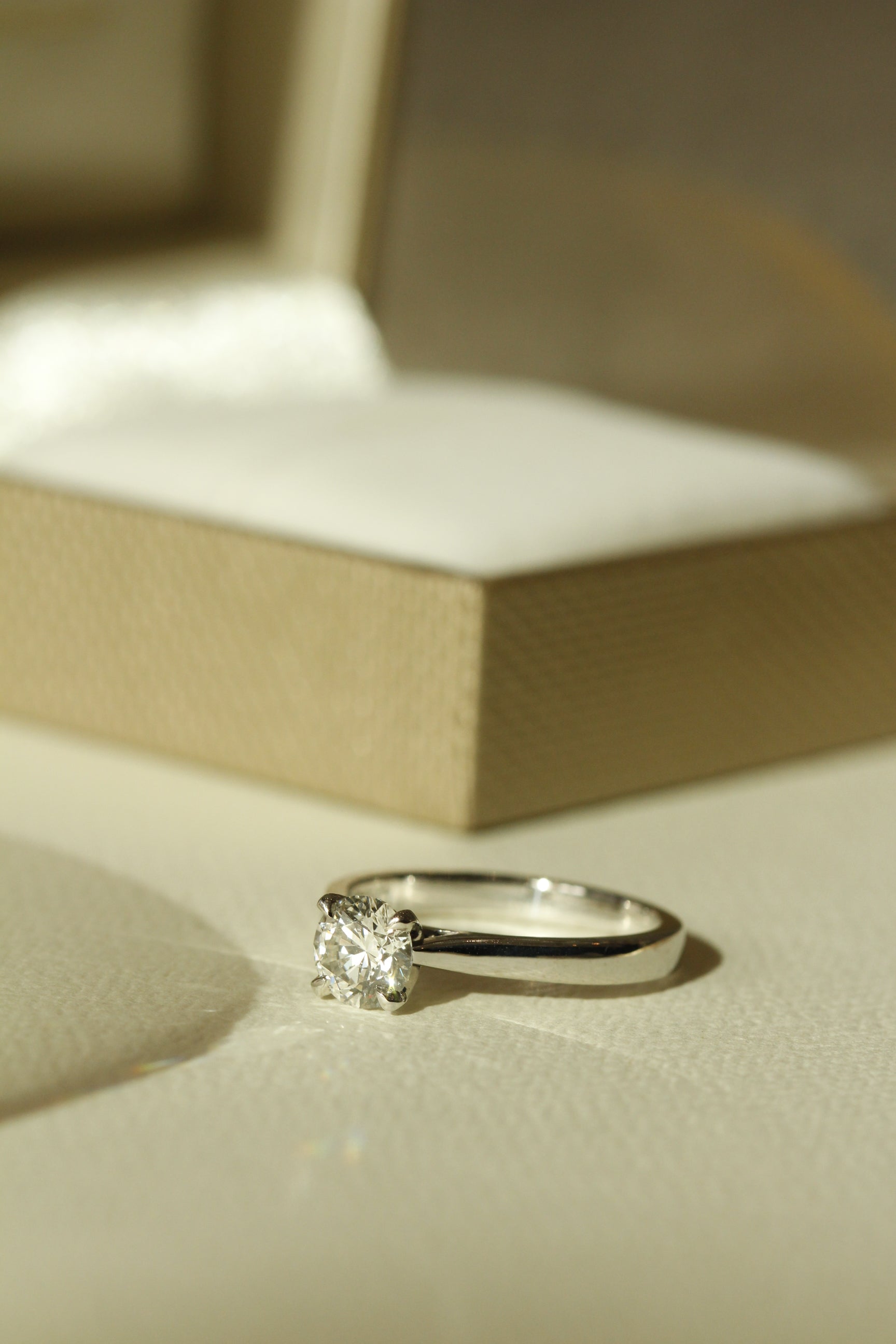 Engagement Ring Brilliant Round Cut Diamond Four Claw Solitaire Setting In Front Of Box 