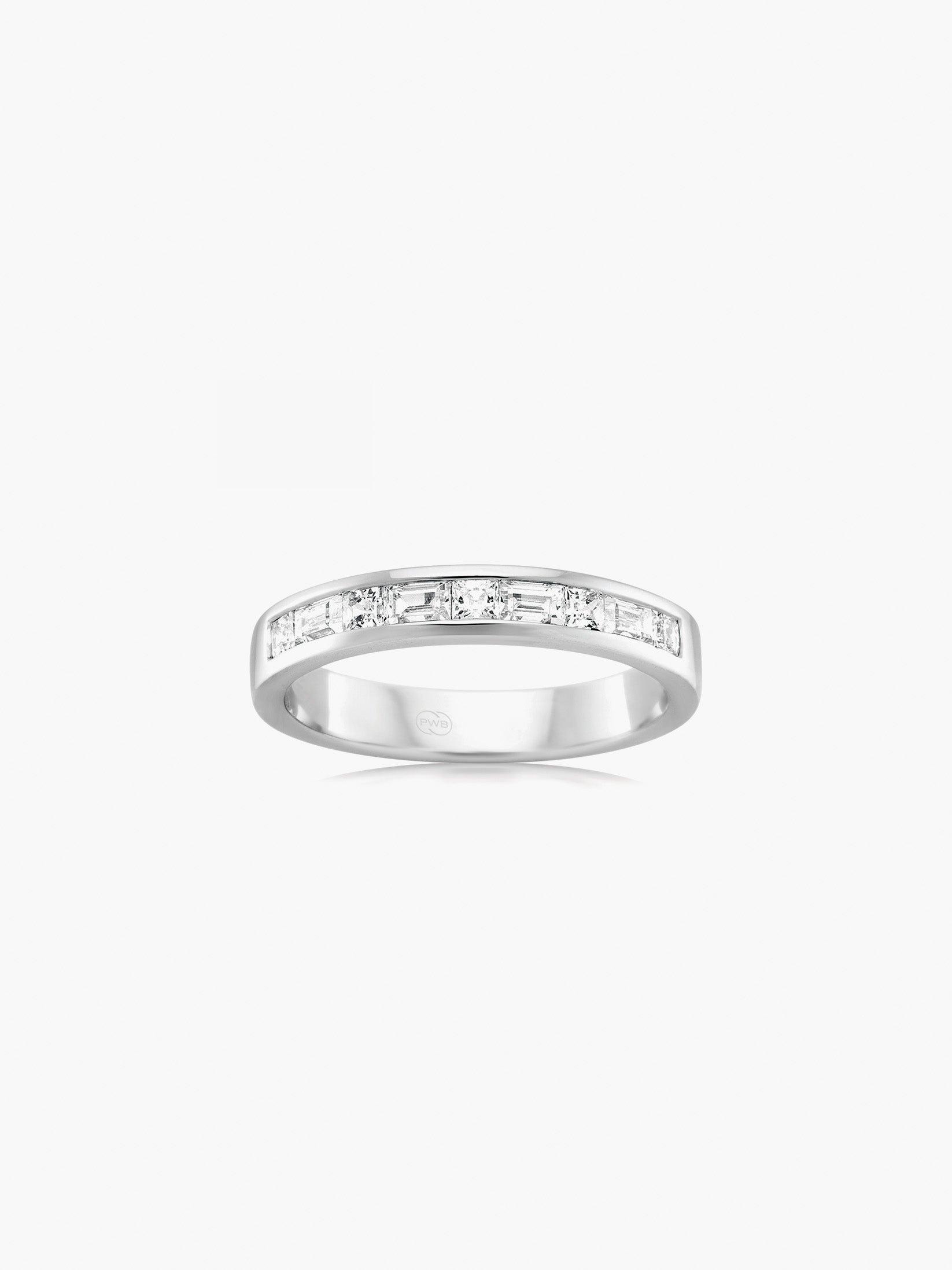This white gold diamond wedding ring features alternating round brilliant and baguette diamonds set across a refined band.