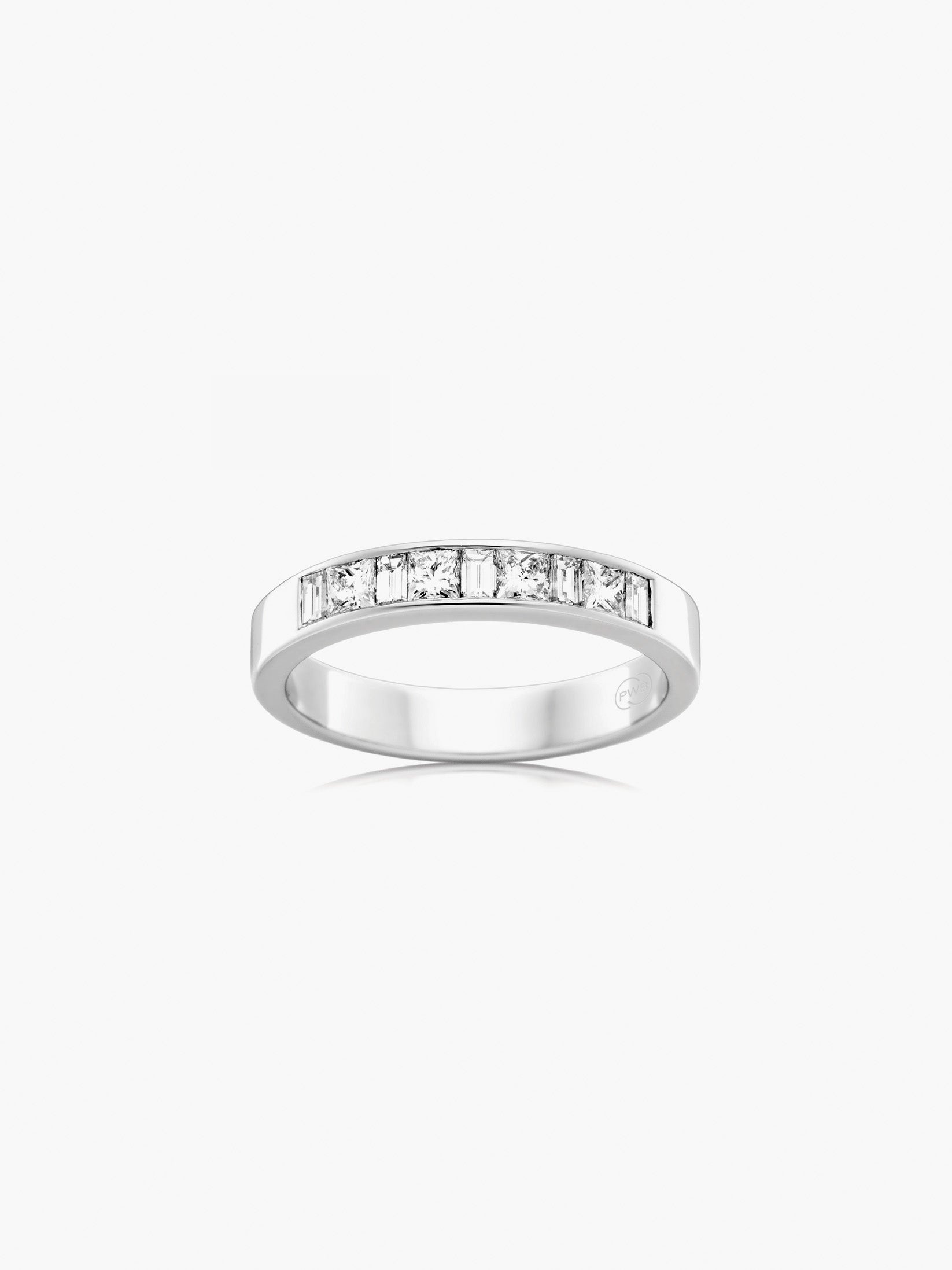 This white gold diamond wedding ring features alternating princess cut and baguette diamonds set across a refined band for a distinctive geometric design.