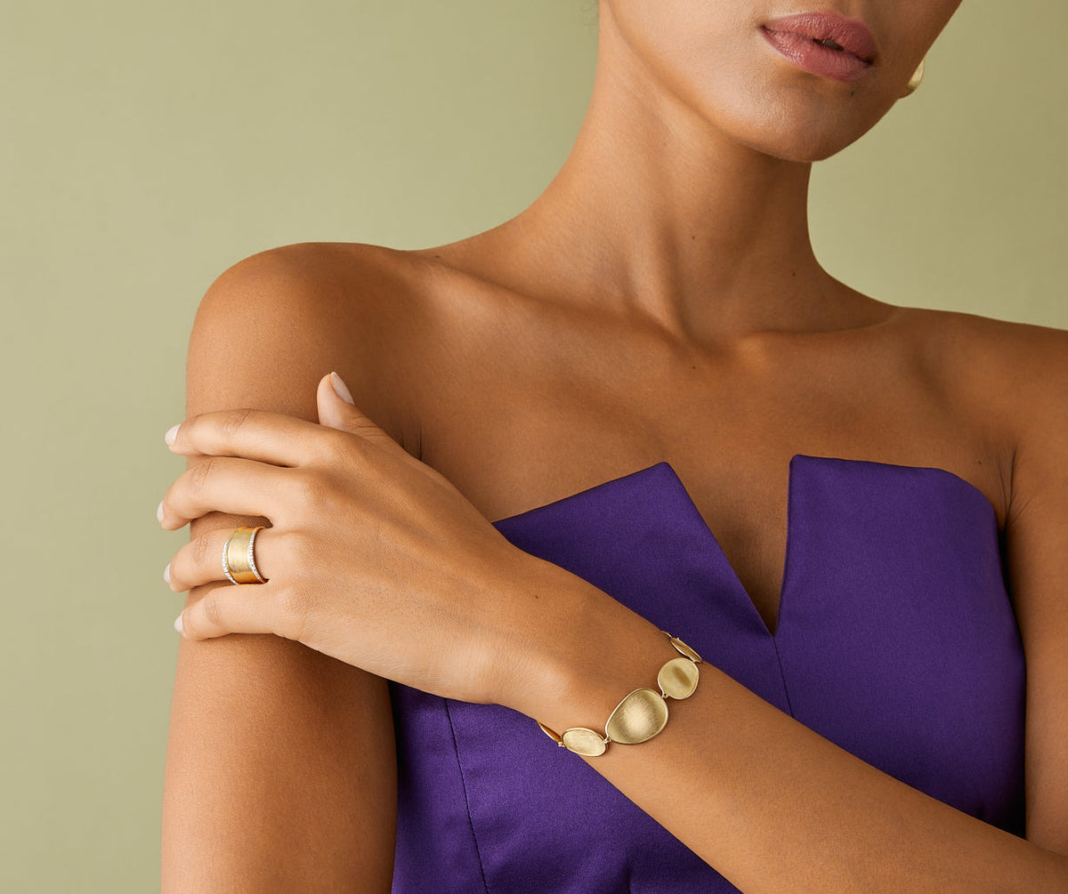 Marco Bicego 18k yellow gold Lunaria bracelet paired with Lunaria ring worn on hand