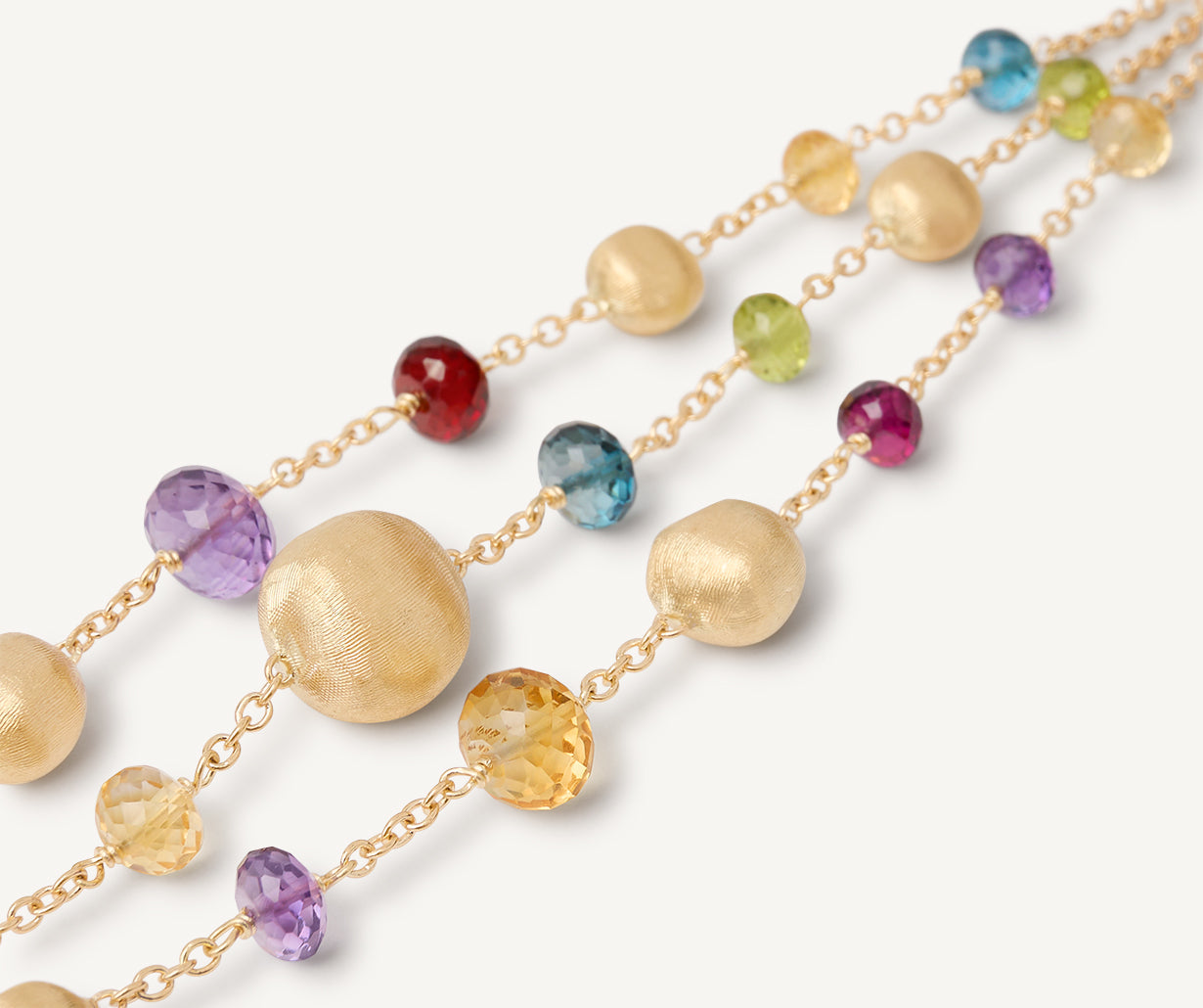 18k Yellow gold and mixed gemstones by Marco Bicego on white background