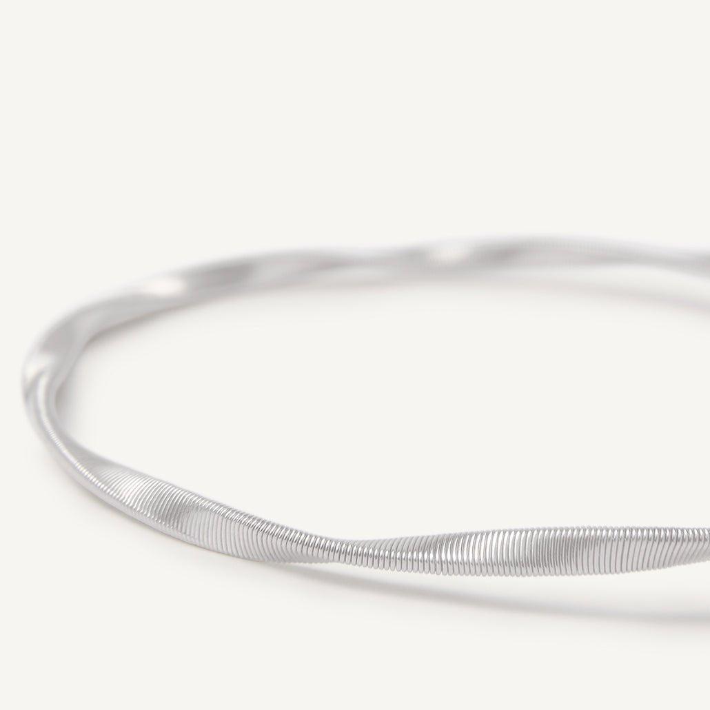 Close up 18k white gold one strand bracelet by Marco Bicego