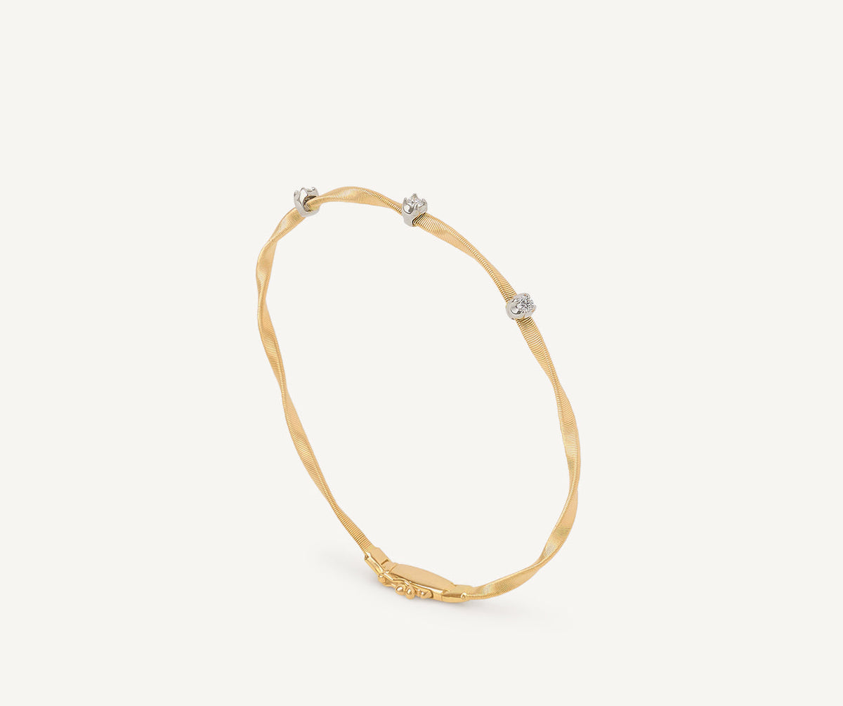 Yellow gold and diamonds one strand Marrakech bracelet on white background