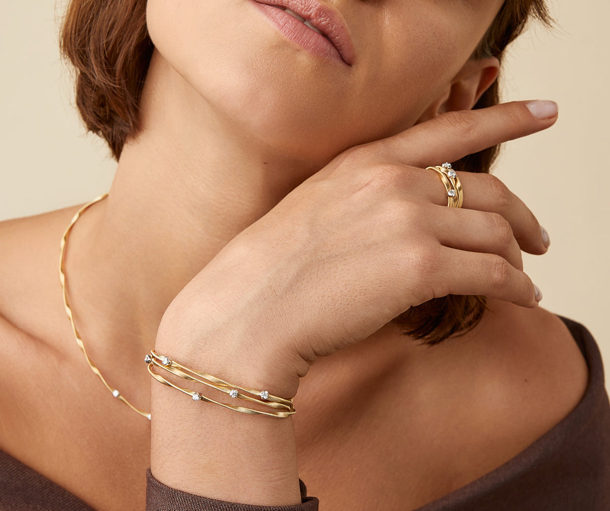 Yellow gold with diamonds three strand Marrakech bracelet worn with Marrakech necklace and ring by Marco Bicego