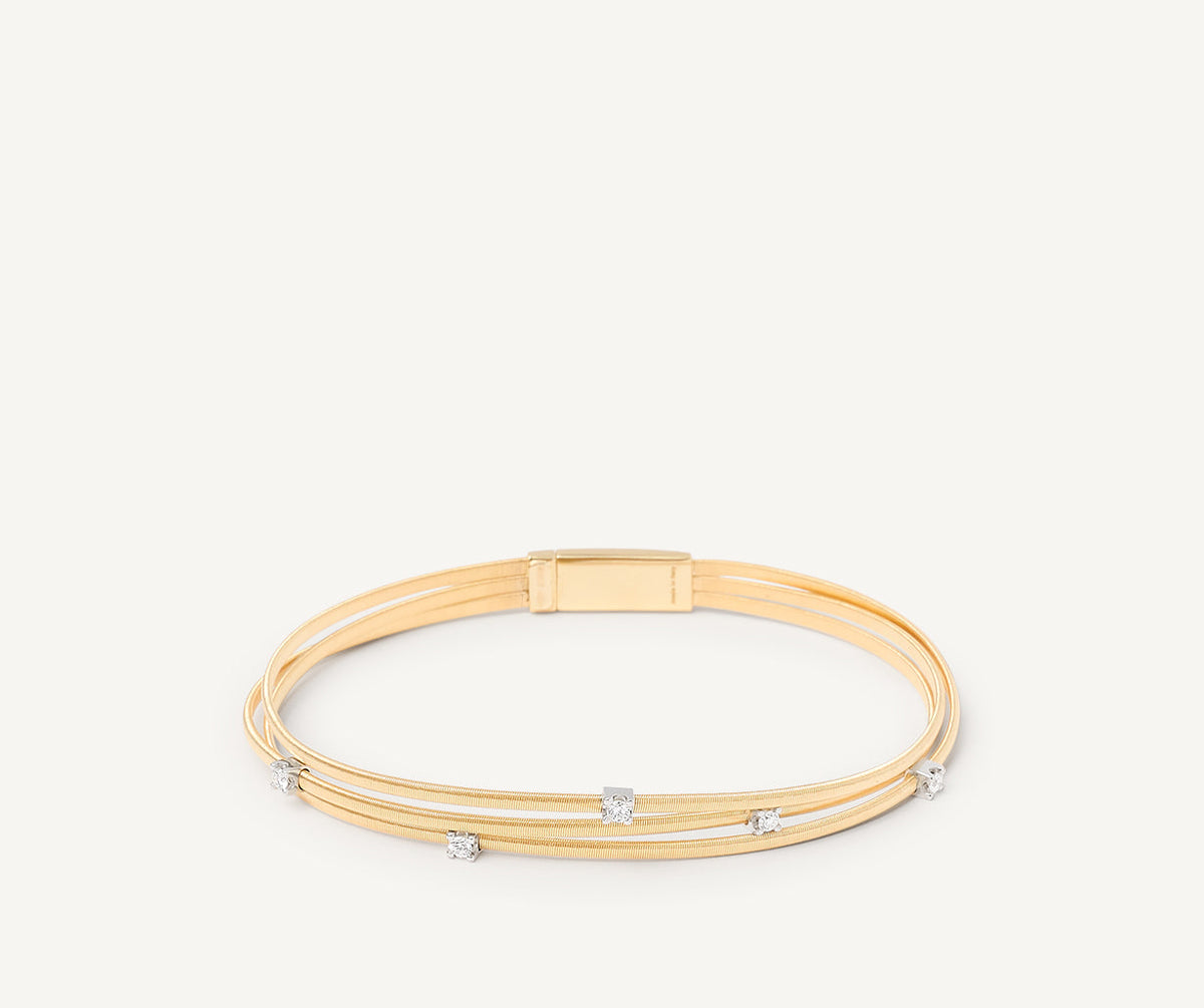 Three strand yellow gold and diamonds Marrakech bracelet on white background