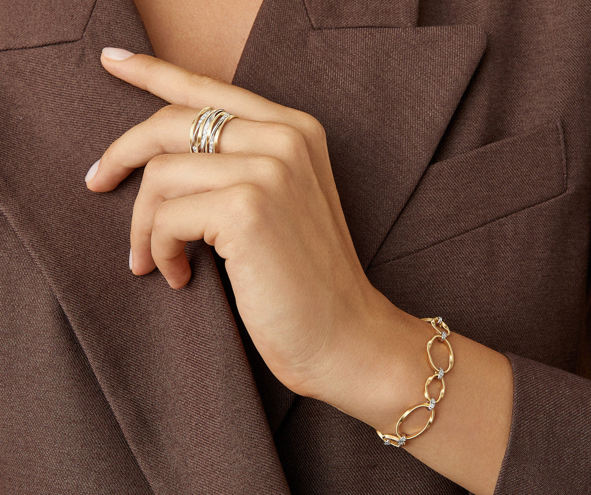 Yellow gold and diamonds MArrakech Onde bracelet worn with Marrakech Onde ring by Marco Bicego