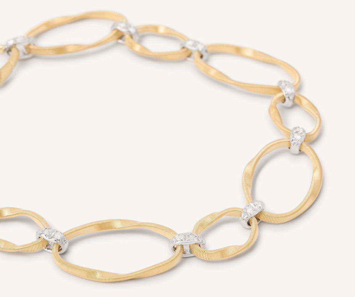 Close up of Marrakech Onde bracelet in 18k yellow gold with diamonds set in 18k white gold