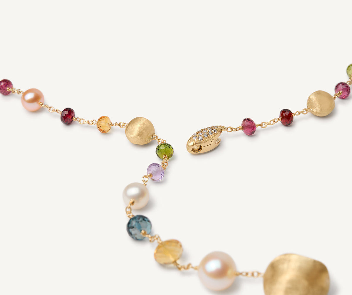 CLose up of mixed gemstones and diamonds set in yellow gold lariat necklace by Marco Bicego from the Africa collection