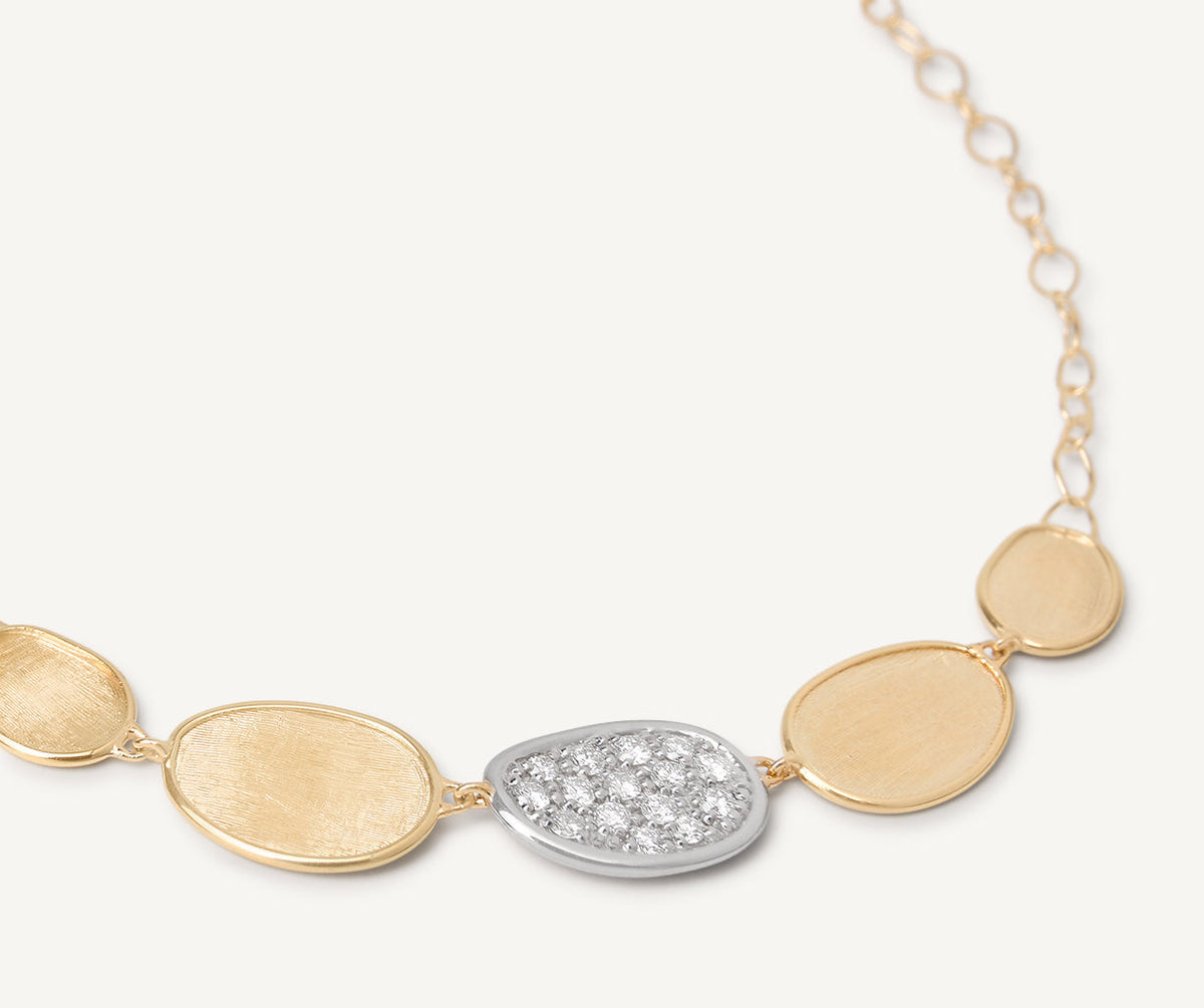 Close up of mini Lunaria necklace in 18k yellow gold and with diamonds set in white gold by Marco Bicego