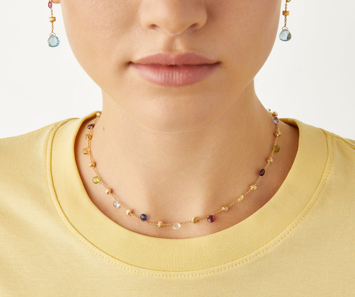 Mixed gemstone and 18k yellow gold Paradise necklace short by Marco Bicego worn with Paradise drop earrings