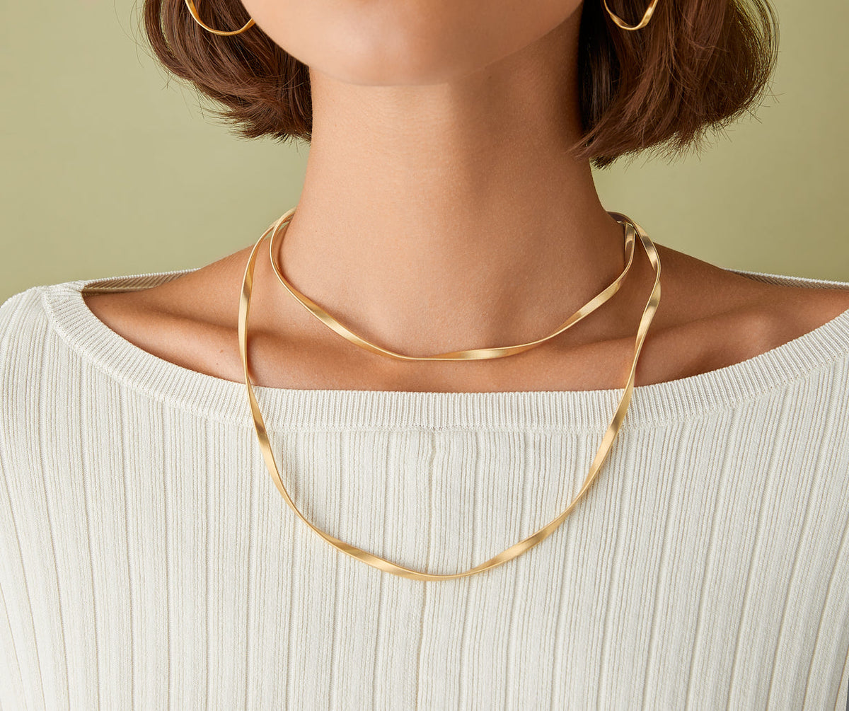 18k yellow gold Marrakech Supreme long necklace in yellow gold worn with Marrakech Supreme yellow gold hoop earrings by Marco Bicego