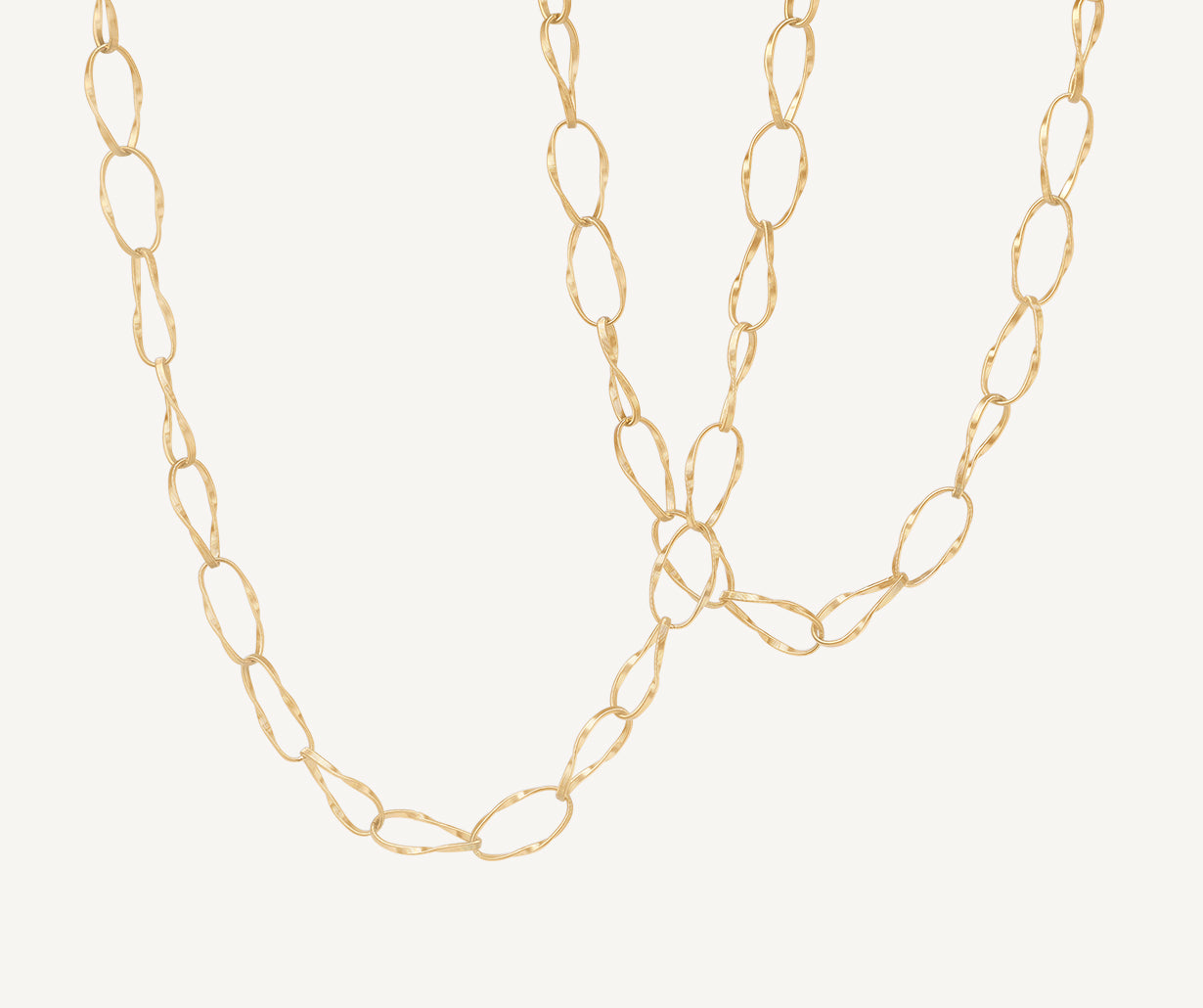 Marco Bicego Marrakech Onde long chain necklace in yellow gold layered wirh Marrakech Onde necklace worn on model