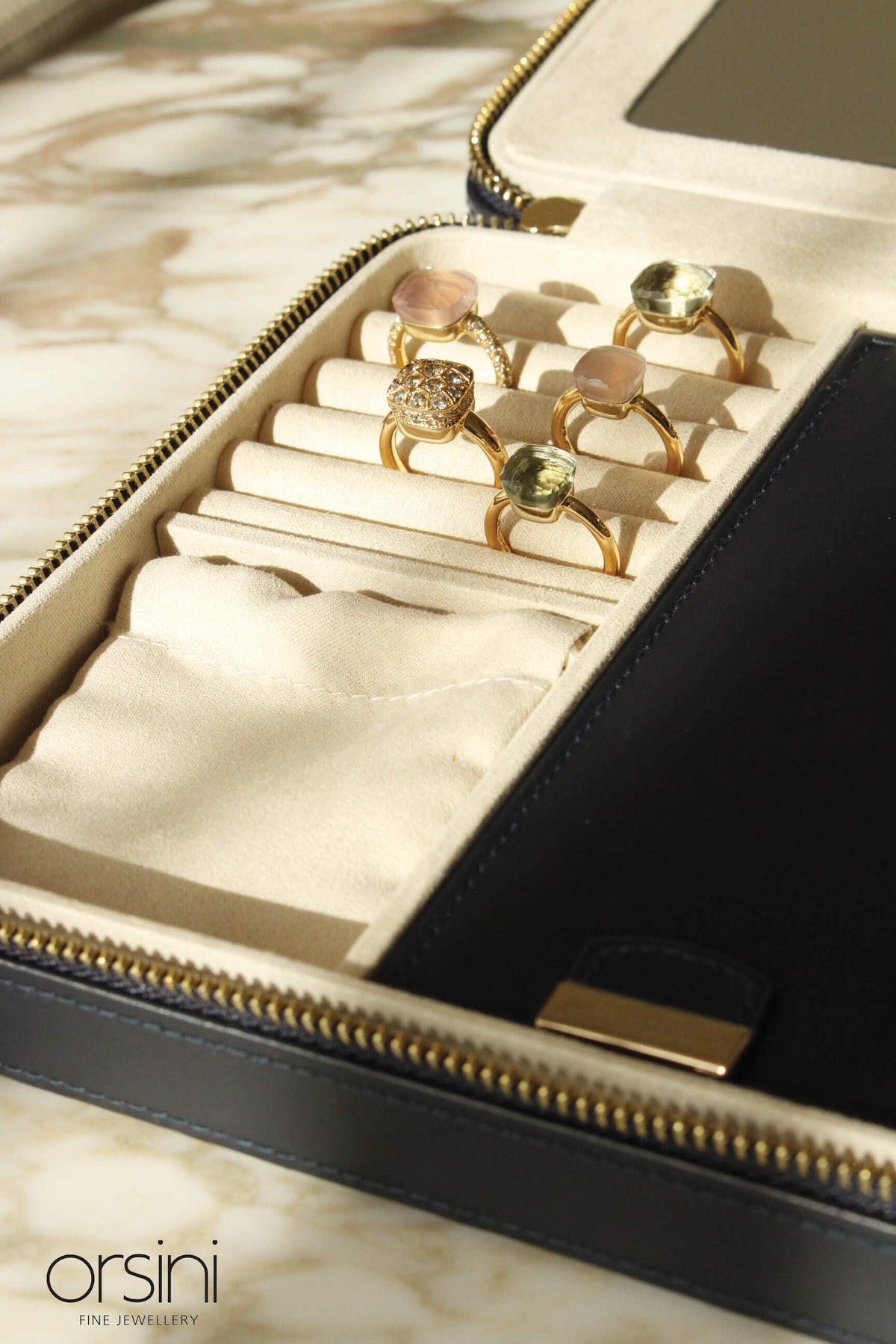 Close up on navy travel jewellery case with diamond nudo rings 