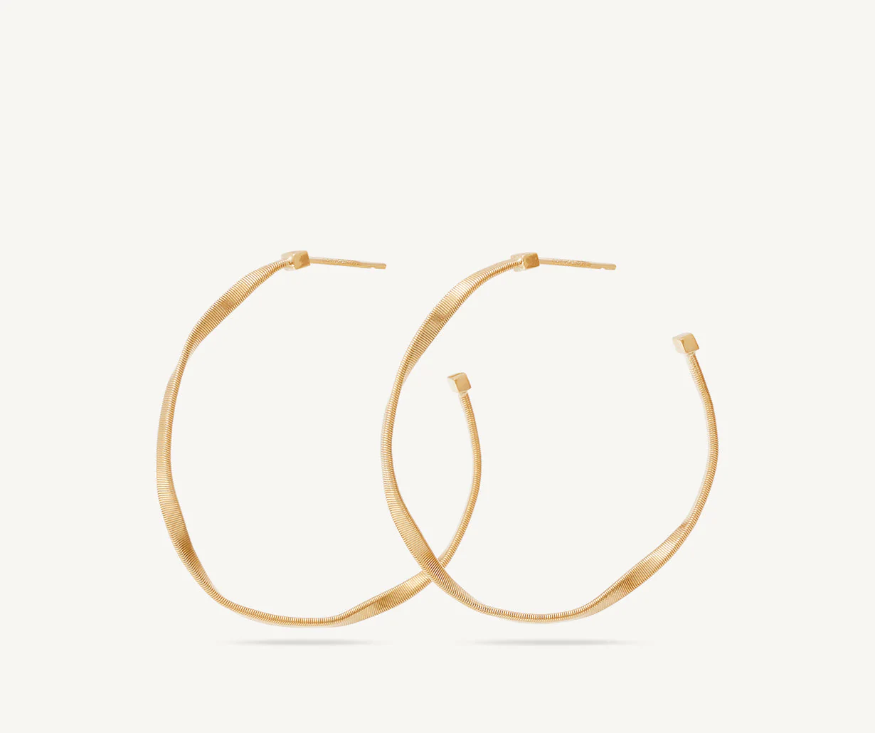 Profile of Marrakech hoops in 18k yellow gold by Marco Bicego 