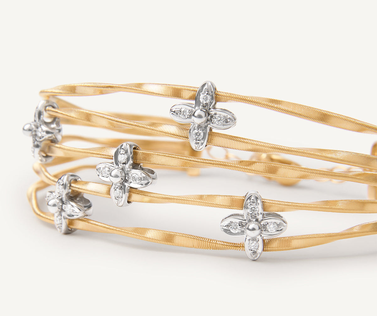 Five strand yellow gold Marrakech Onde bracelet with diamond flowers by Marco Bicego